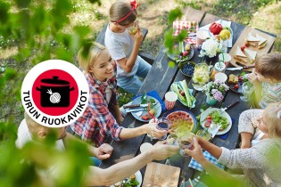 Kuvassa ihmisiä nauramassa ja syömässä piknik-pöydän ääressä, sekä Turun ruokaviikkojen logo.