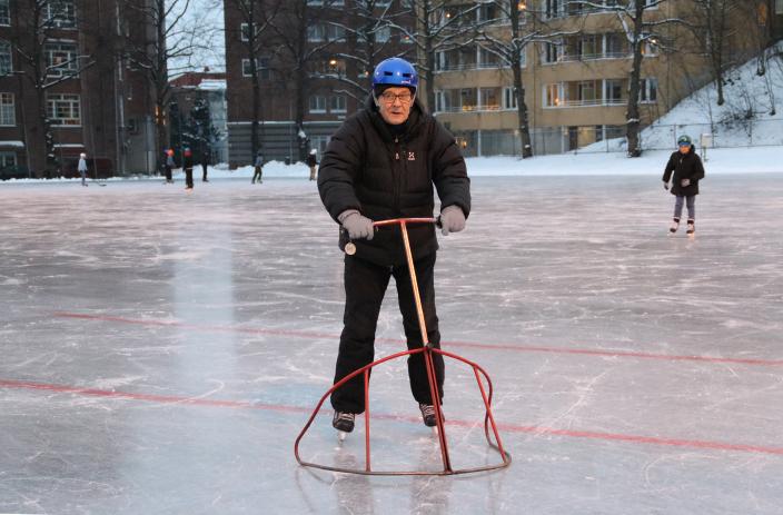 An older man skates with skate assist aid on a skating rink. (Picture: Kai Salonen)
