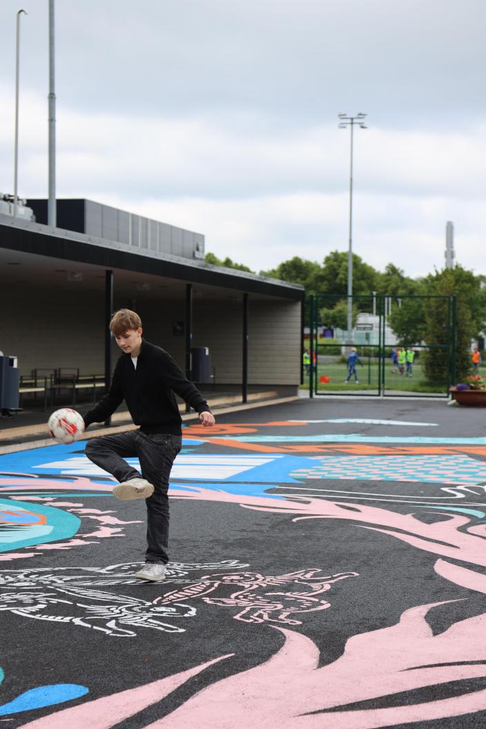 Nuori potkii palloa Kupittaan monitoimikentällä.