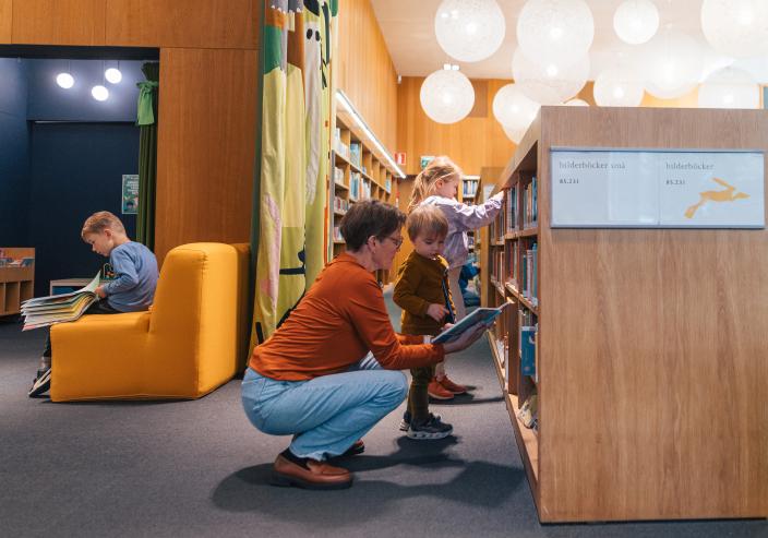 Lapsia ja aikuisia lukemassa pääkirjaston lastenosastolla. (Foto: Heikki Räisänen)