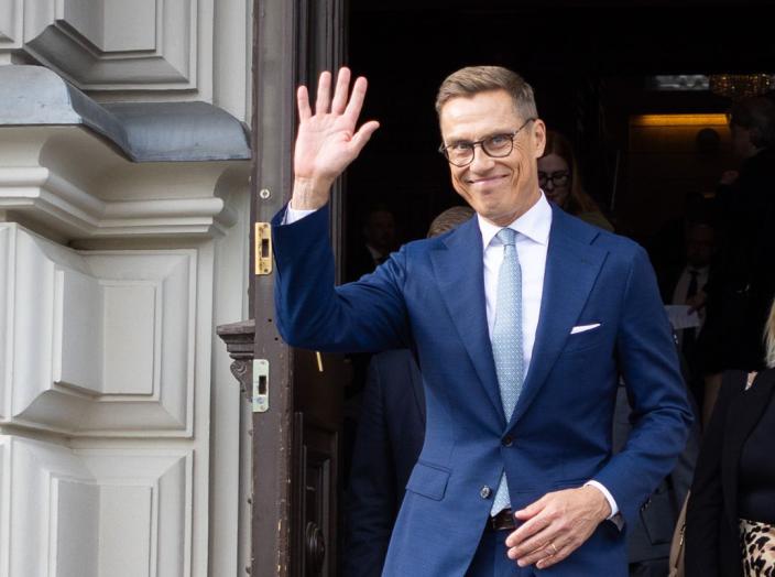 Presidentti Stubb laskeutuu ulko-ovesta portaita ja vilkuttaa yleisölle. (Kuva: Matti Porre/Tasavallan presidentin kanslia)