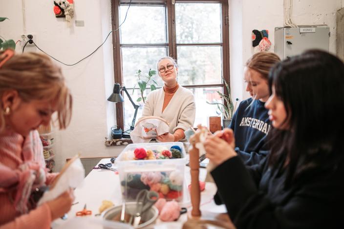 Människor som gör textilkonst. (Kuva: Jussi Virkkumaa)