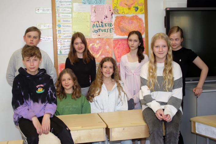 Alakoulun oppilaat poseeraavat luokkahuoneessa.  (Kuva: Hannele Sivonen)